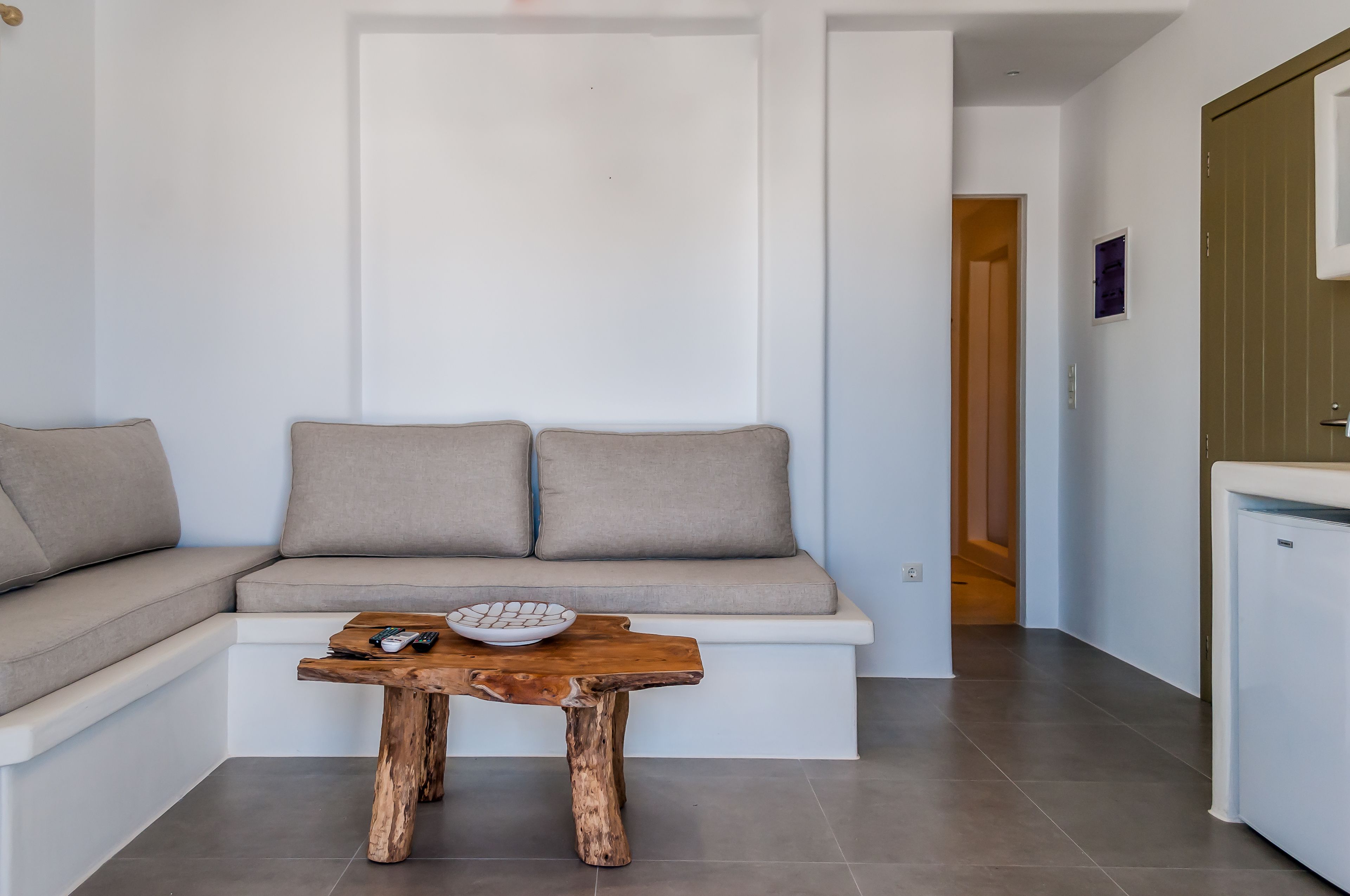 A modern living room with a built-in bench and a wooden coffee table.