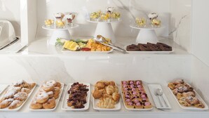 A buffet with various food items including pastries, fruits, and desserts. - The Duke Boutique Hotel (Victoria)