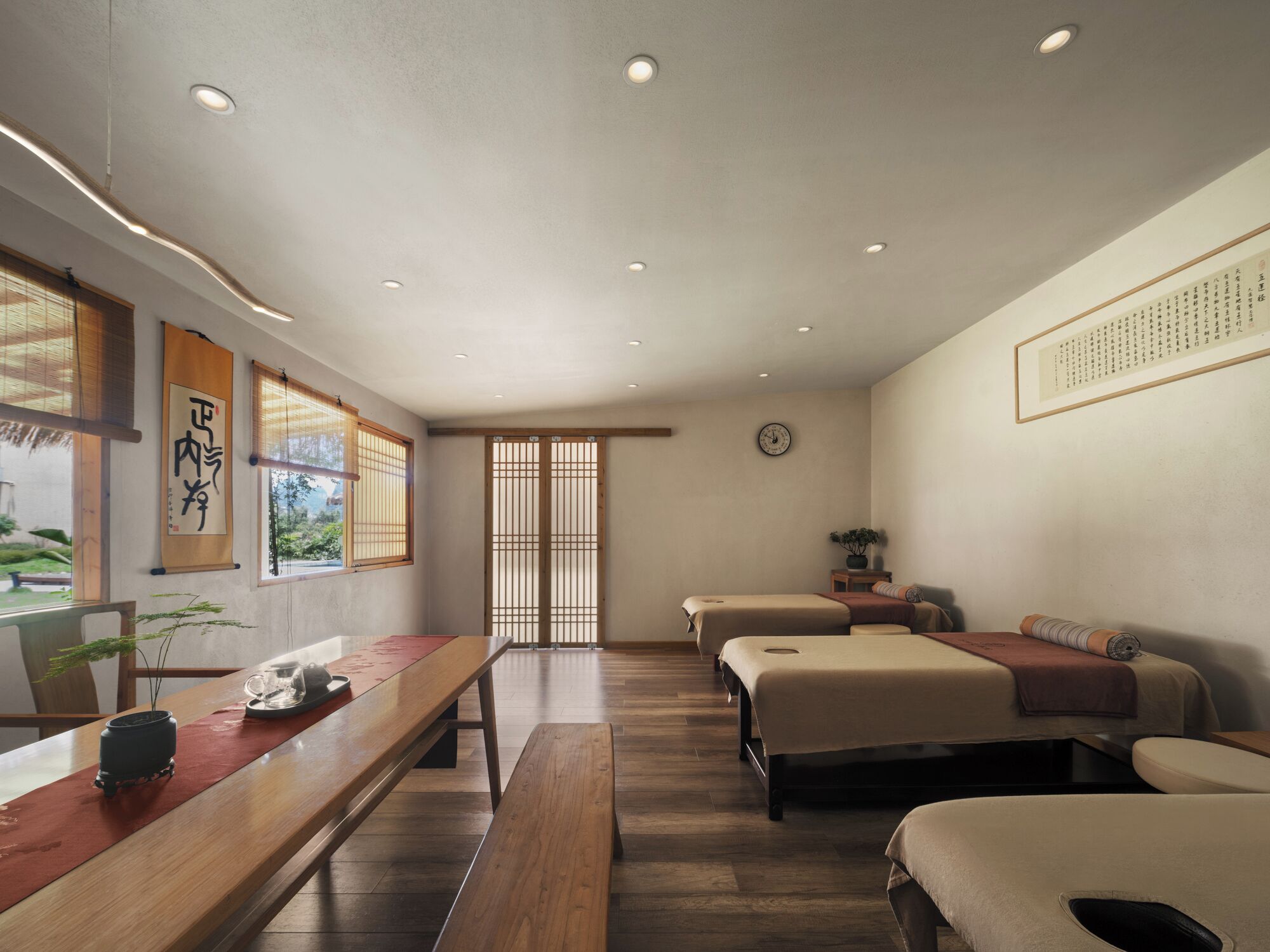 A traditional Japanese-style room with tatami flooring, a low wooden table, two tatami beds, and a shoji screen door.