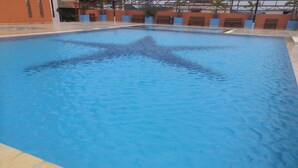 A swimming pool with a starfish design on the water. - Globallon Hotel Apartment (Malacca City)
