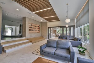 Una sala de estar moderna con un sofá gris, una mesita de centro y una estantería.