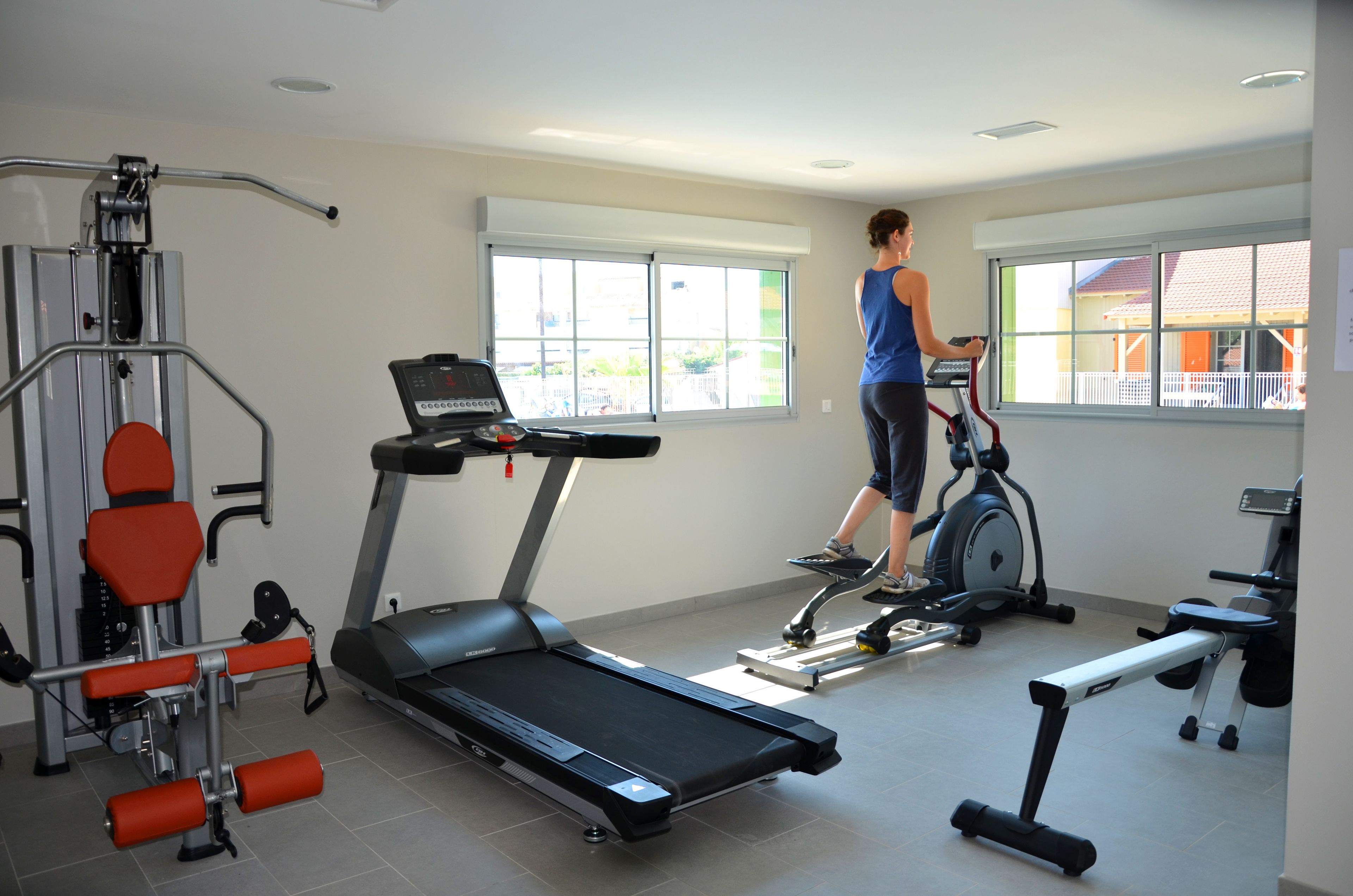 A gym with treadmills, a stationary bike, and weight machines.