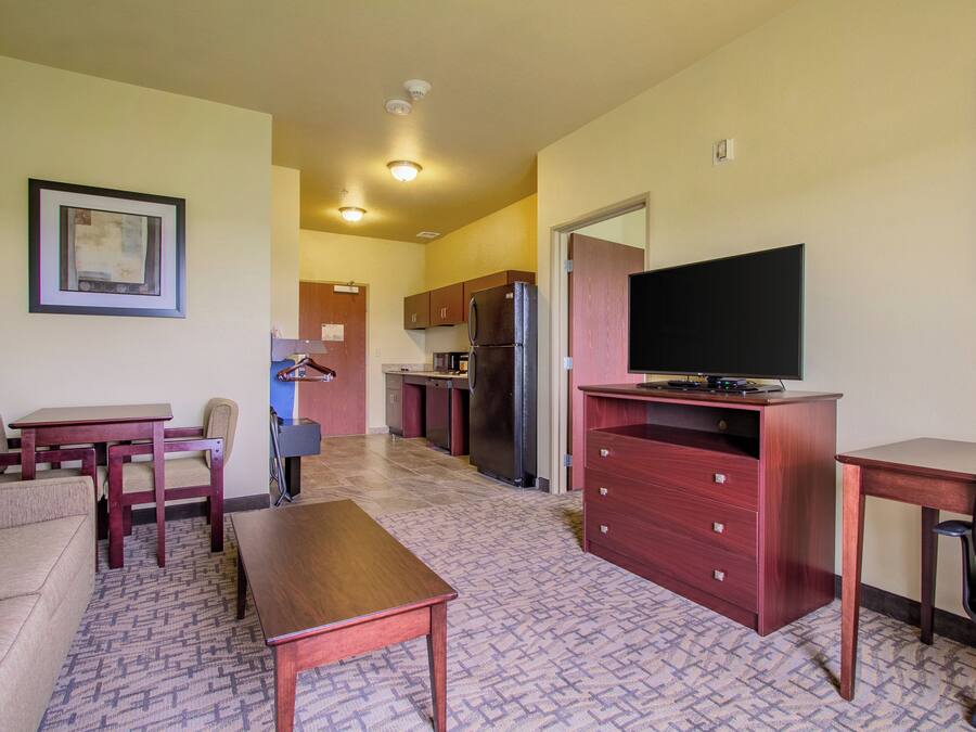 A compact living space with a kitchenette, a dining area, and a seating area.