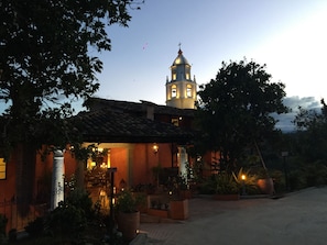 A building with a bell tower and a sign indicating it is a hotel. - Hotel Monasterio San Agustín (San Agustin)