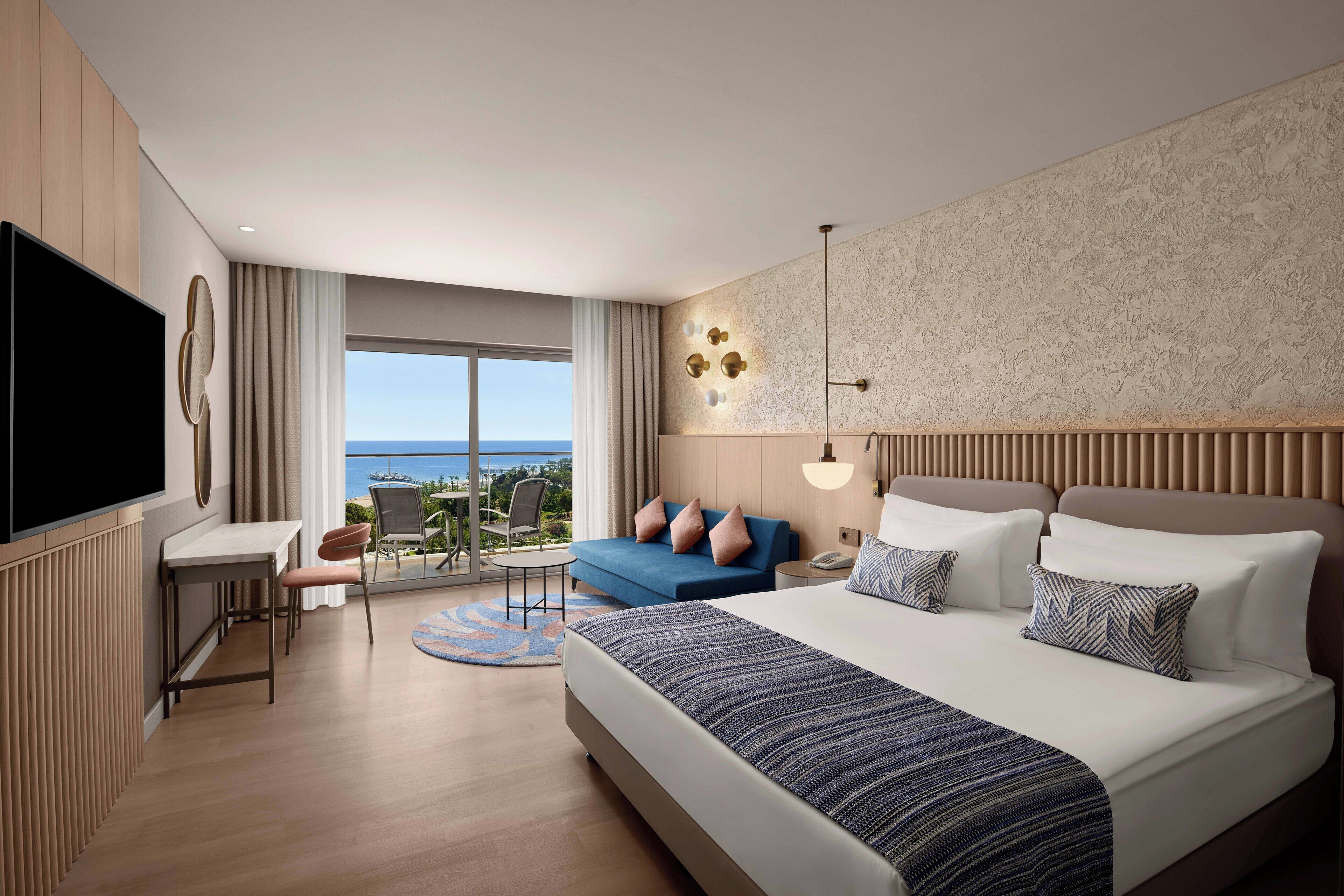 Deluxe Room, Sea View (Mixed Section) | Minibar, in-room safe, desk, iron/ironing board