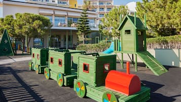 Children can play on a train set in this outdoor play area.