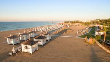 On the beach, sun loungers, beach umbrellas, beach towels