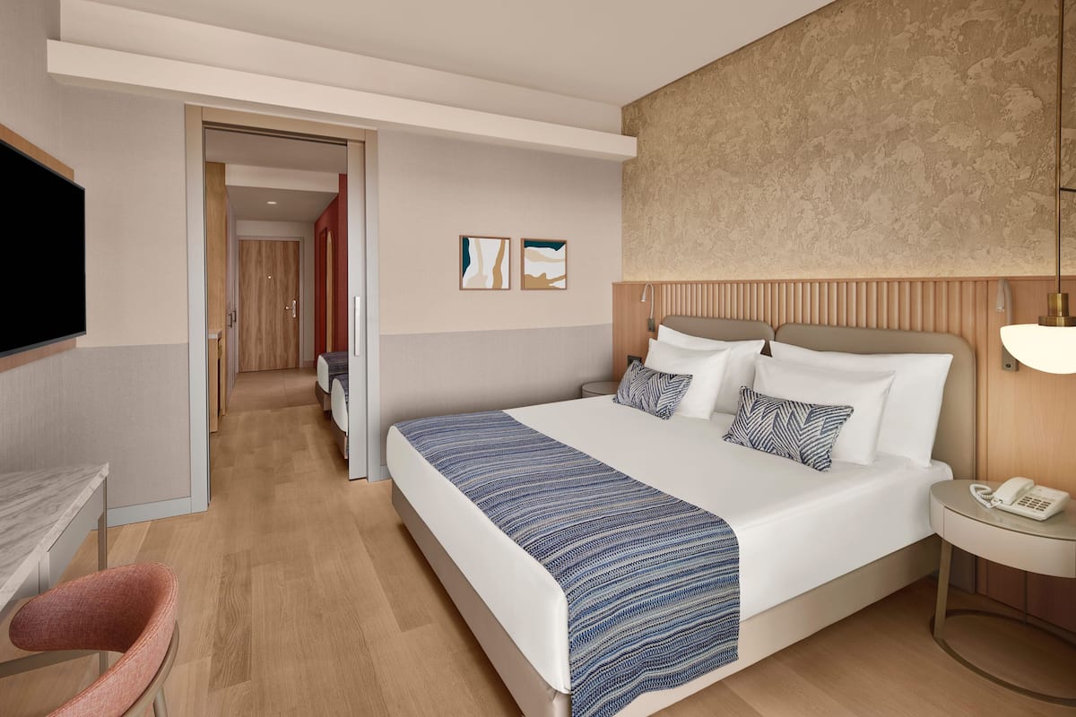 Family Room, Sea View | Minibar, in-room safe, desk, iron/ironing board