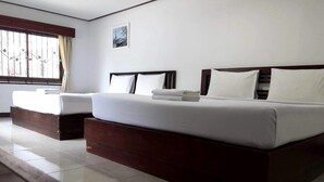 A modern hotel room with a large bed, a smaller sofa, and a window with curtains. - Fahproundfon Hotel (Nakhon Ratchasima)