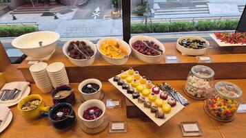 A buffet with various food items and utensils.