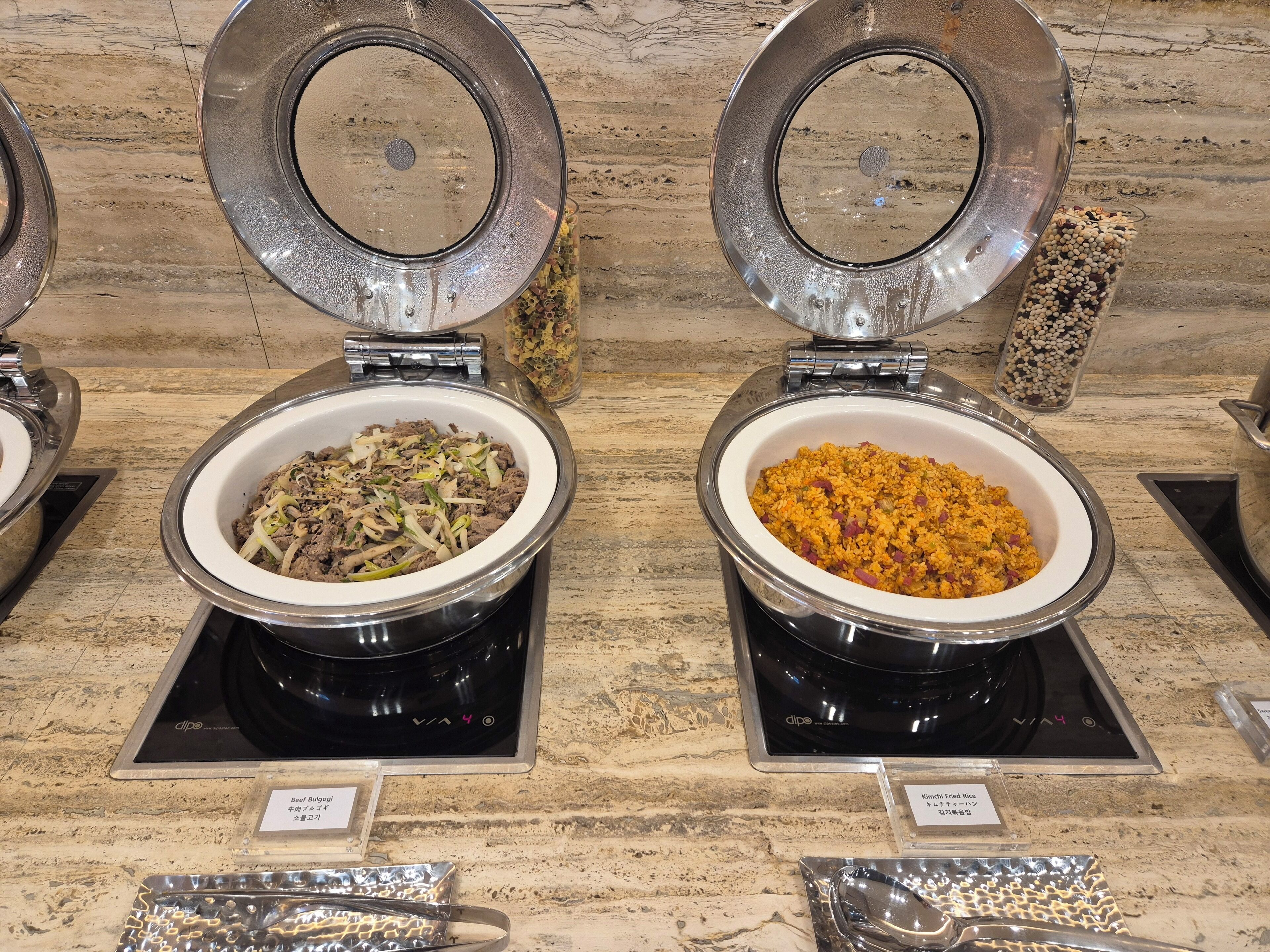 Two self-service food dispensers with labels for Beef Bulgogi and Kimchi Fried Rice.