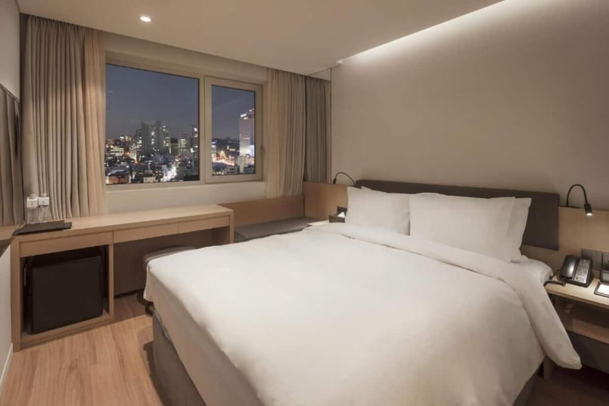 Ropa de cama de alta calidad y caja de seguridad en la habitación 