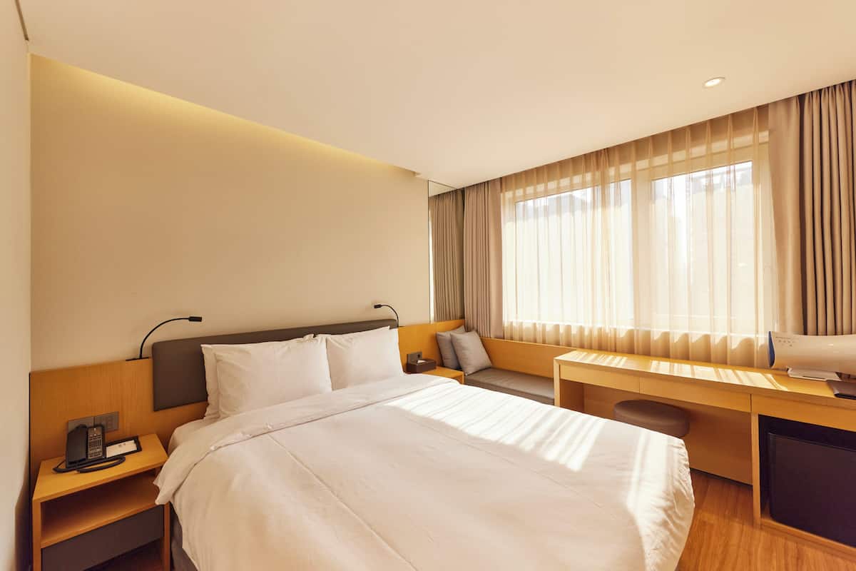 Ropa de cama de alta calidad y caja de seguridad en la habitación 