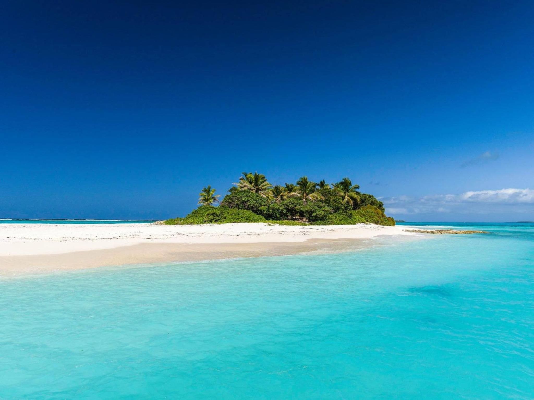 A tropical island with white sand beaches and clear turquoise waters.