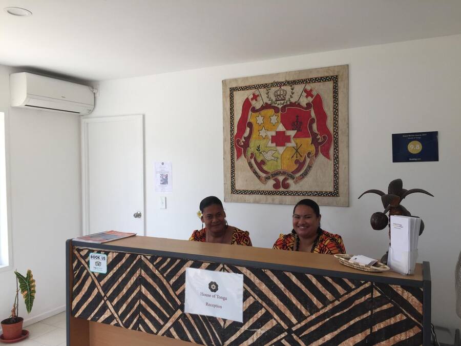 A reception desk with a sign reading "House of Tonga Reception".