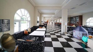 A spacious hotel lobby with checkered flooring, seating areas, and large windows. - Empire Pacific Castle (Taoyuan City)