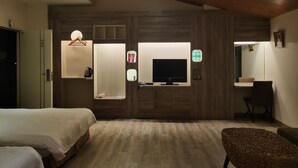 A modern hotel room with a wooden ceiling, a large TV, a sofa, a small table, and a bed. - Empire Pacific Castle (Taoyuan City)