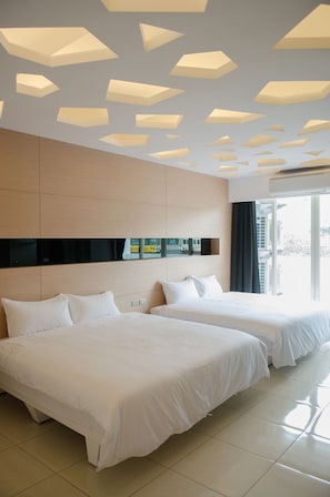 A hotel room with two beds, a large window, and a modern ceiling design. - Apple Tree B&B (Hualien City)