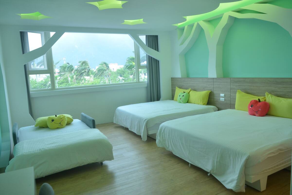 A hotel room with two beds, a large window with a view, and a unique ceiling design.