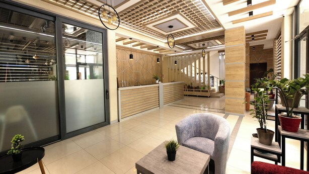 A modern lobby with a reception desk, seating area, and potted plants. - Sayyoh Hotel (Tashkent)