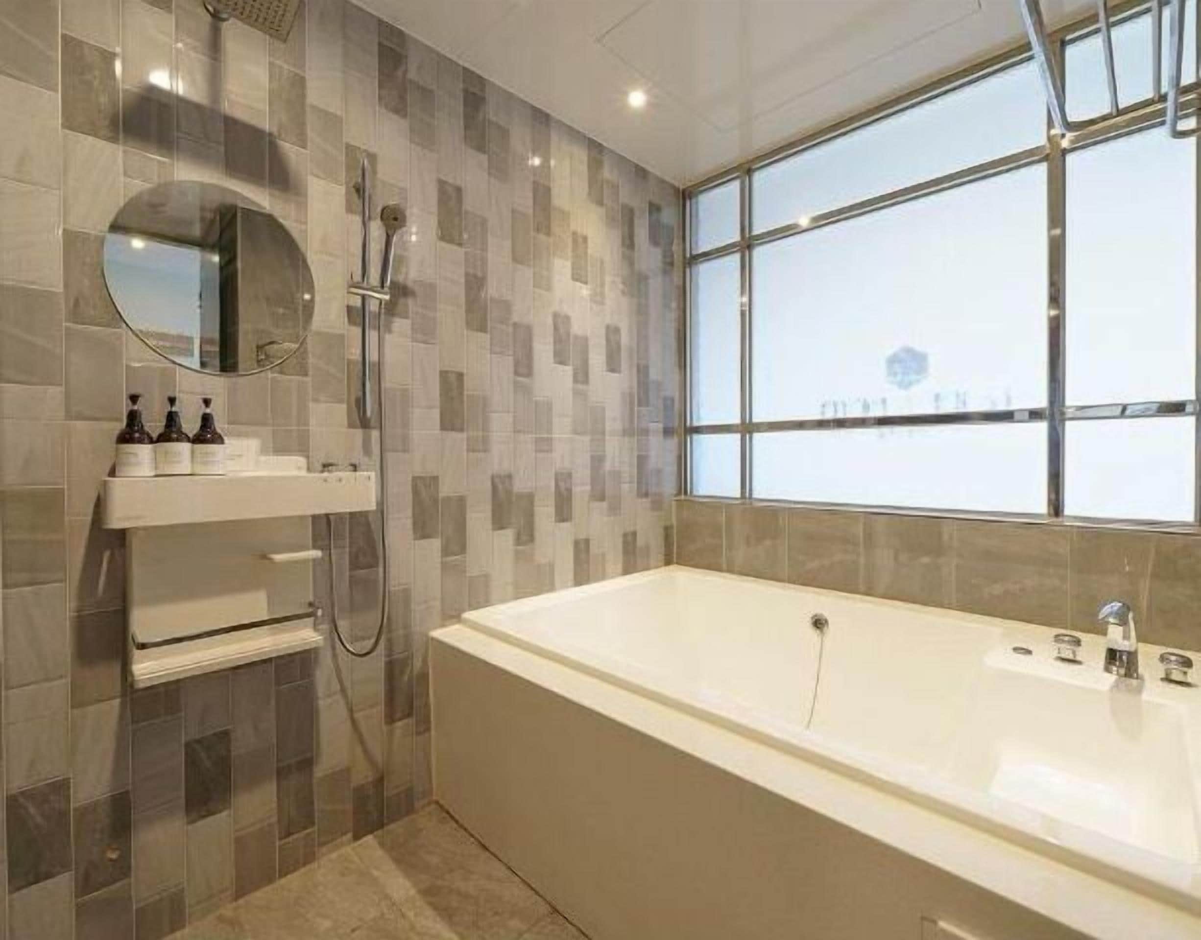 separate bathtub and shower, hair dryer, bathrobes, slippers