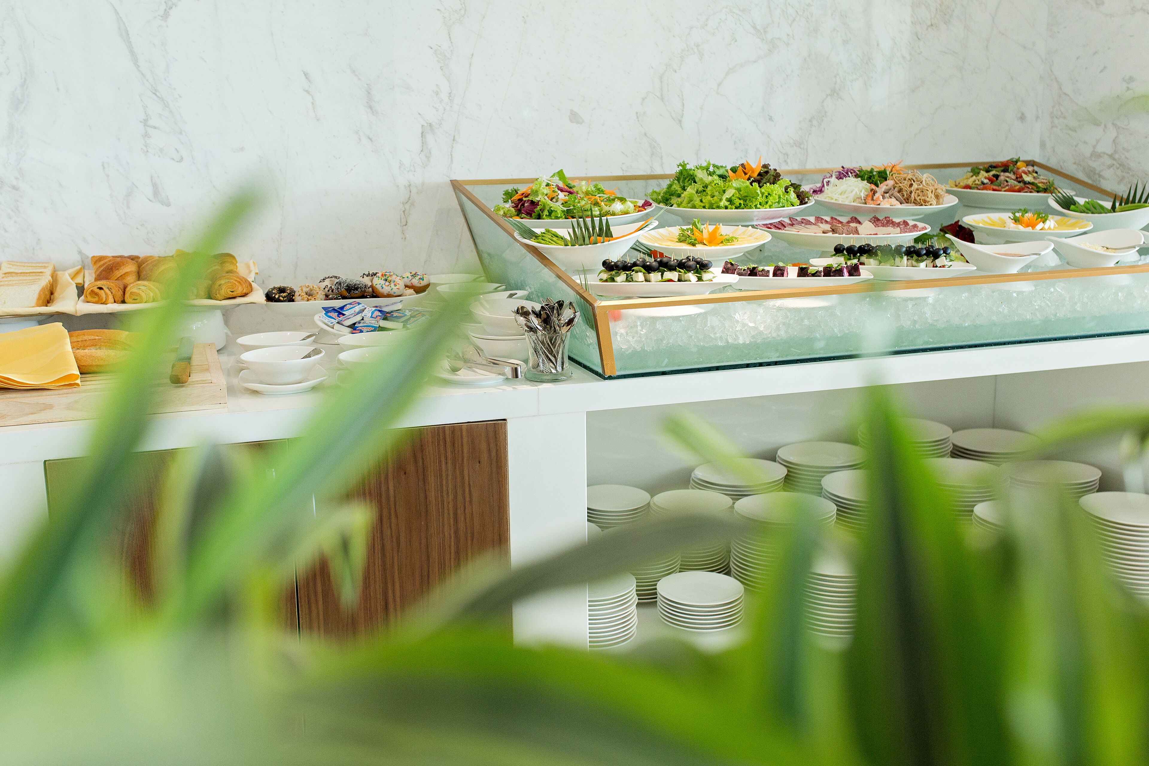 A buffet with various dishes and a glass display case.