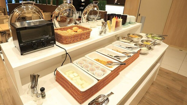 A buffet setup with various food items and condiments. - Smile Hotel Hakata Ekimae (Fukuoka)