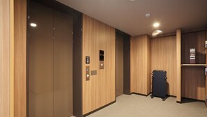 A modern elevator with a control panel and a luggage cart. - Smile Hotel Hakata Ekimae (Fukuoka)