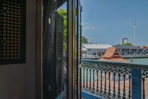 A view from a balcony with a metal railing, overlooking a body of water, buildings, and a tall communication tower. - 5 Heeren (Malacca City)