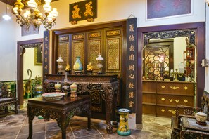 A traditional Chinese interior with ornate furniture, a chandelier, and a sign with Chinese characters. - 5 Heeren (Malacca City)