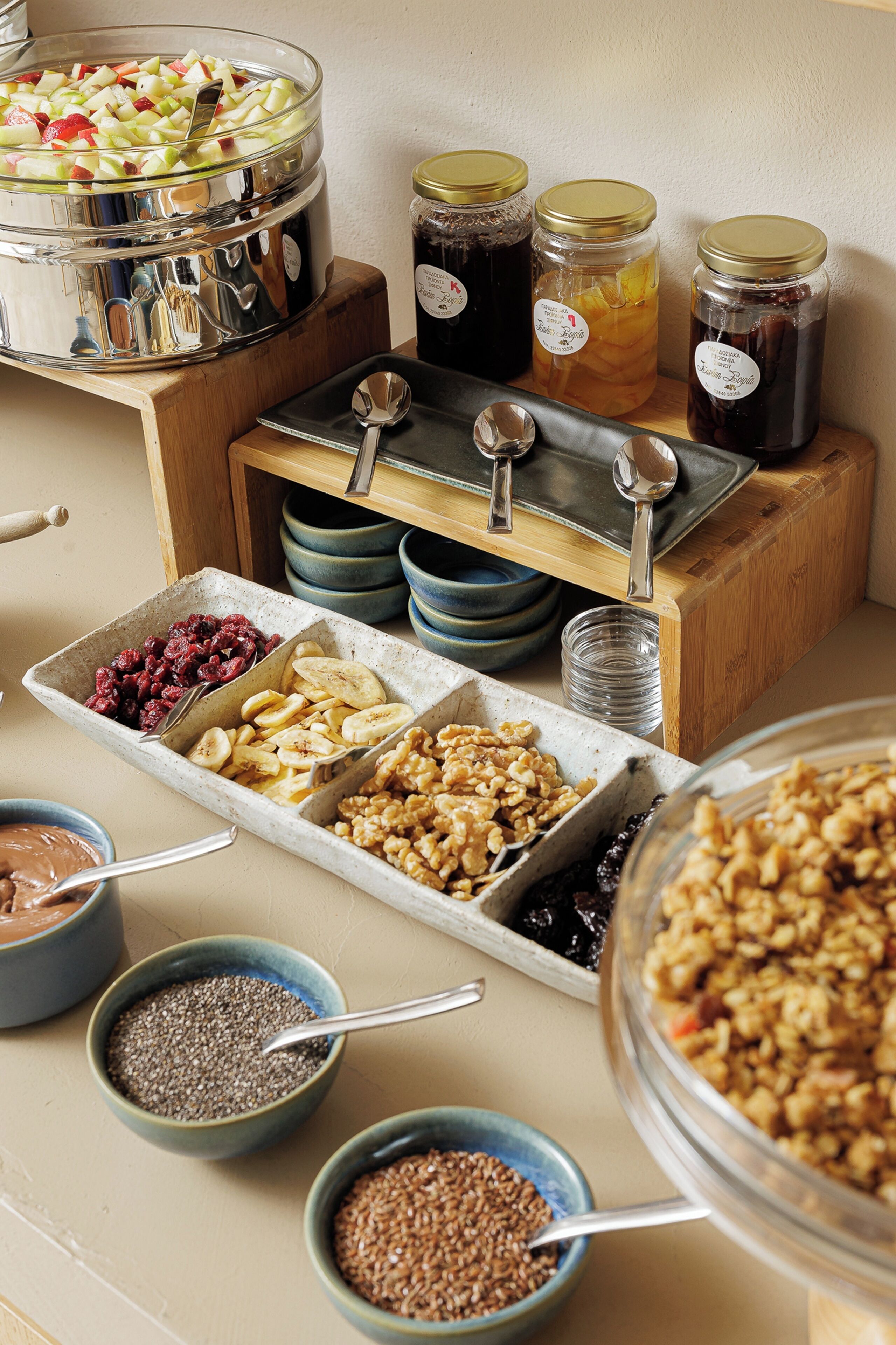 A buffet with various food items including fruits, nuts, and grains.
