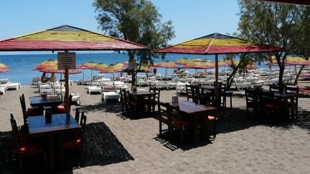 A beachside restaurant with outdoor seating, umbrellas, and a view of the sea. - Yahsi's Yahsi Resort Aparts (Bodrum)