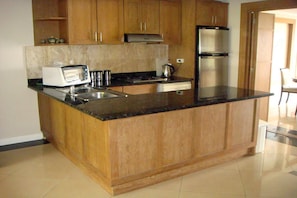 Two Bedroom Apartment | Private kitchen | Full-size fridge, microwave, stovetop, coffee/tea maker