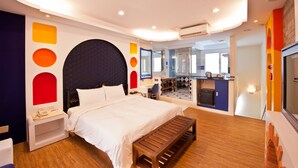A modern hotel room with a large bed, a desk, and a bathroom visible through an open door. - Yudali HR Motel (Donggang)