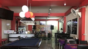 A billiards table, a pool table, and a bar area with a counter and stools. - Bua Khao Paradise (Pattaya)