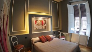 A bedroom with a bed, a chair, a desk, and a window with blinds. - Residenza Maiano (Florence)