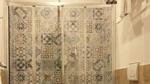 A bathroom with a shower enclosure, toilet, and sink. - Residenza Maiano (Florence)