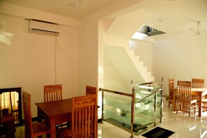 Ein modernes Interieur mit Essbereich, Treppe und Klimaanlage.