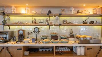 A kitchen with wooden shelves, various kitchenware, and a clock.