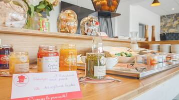 A breakfast buffet with various food items and condiments.