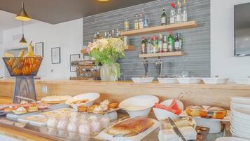 A buffet with various food items and beverages.