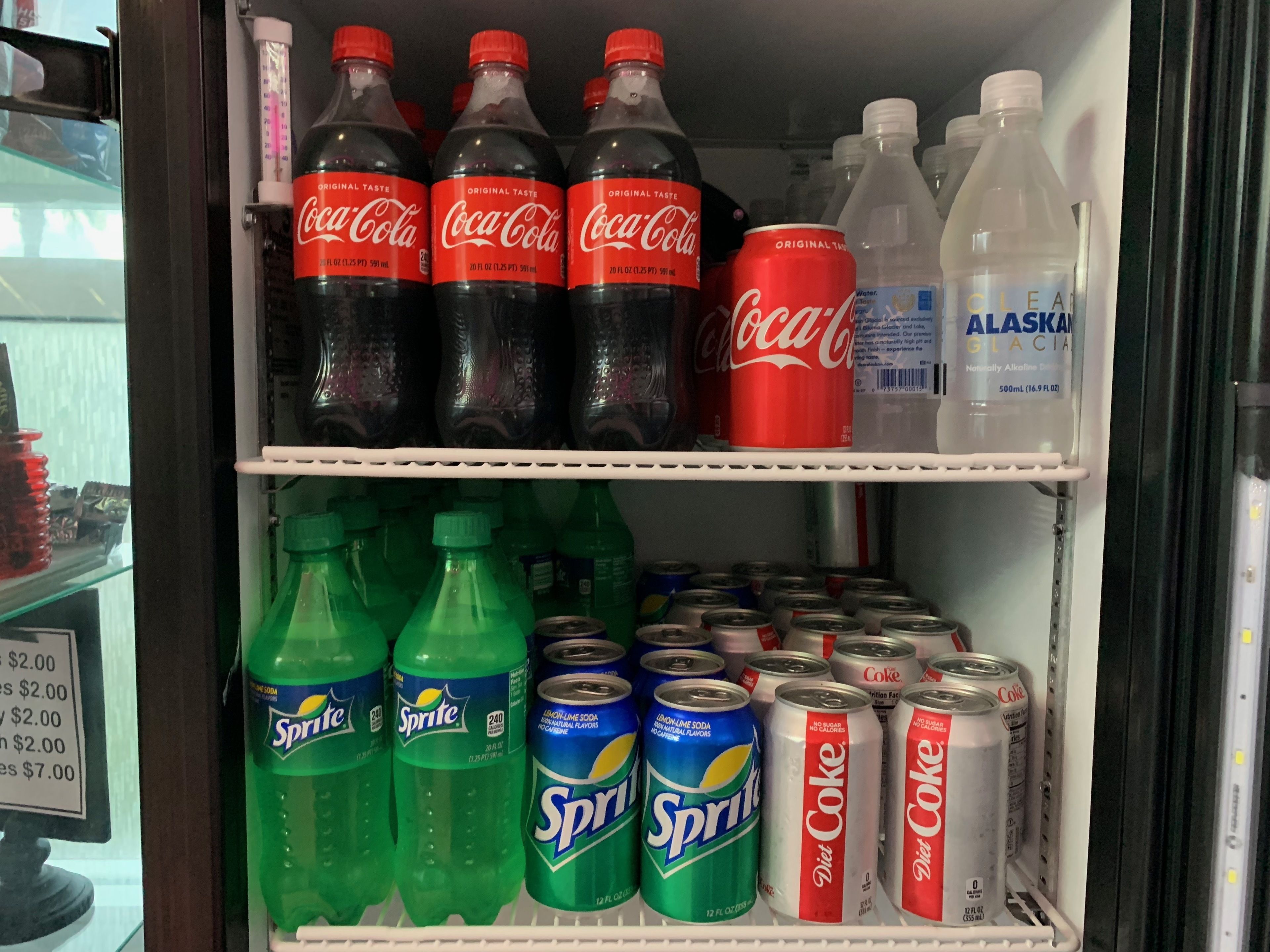 Frigorifero per bevande pieno di Coca-Cola, Sprite, Diet Coke e acqua glaciale dell'Alaska.