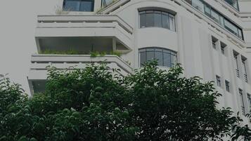 A multi-story building with balconies and large windows.