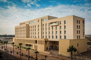 A modern hotel with a flat facade, multiple windows, and a prominent signage.