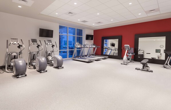 A gym with treadmills, elliptical machines, and a rowing machine. - Hilton Garden Inn Ft. Walton Beach (Fort Walton Beach)