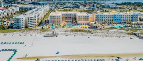 A resort with multiple hotel buildings, a beach, and a water park.
