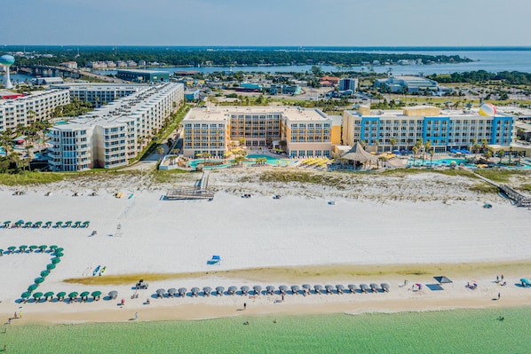 A resort with multiple hotel buildings, a beach, and a water park. - Hilton Garden Inn Ft. Walton Beach (Fort Walton Beach)