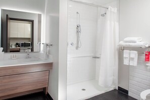 A modern bathroom with a shower, toilet, and sink. - TownePlace Suites by Marriott Dallas Downtown (Dallas)