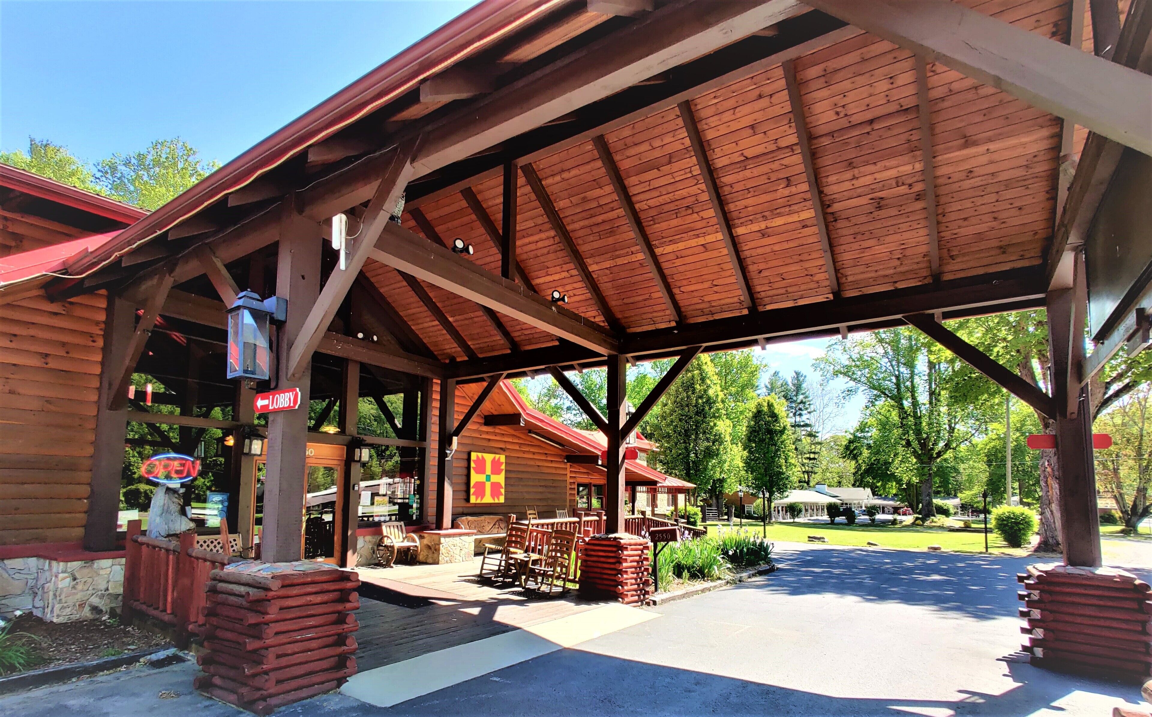 A covered wooden building with a sign indicating a lobby.