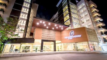 Welcome to The Col. Luxury Design, featuring a striking entrance with a large illuminated sign and modern architecture.